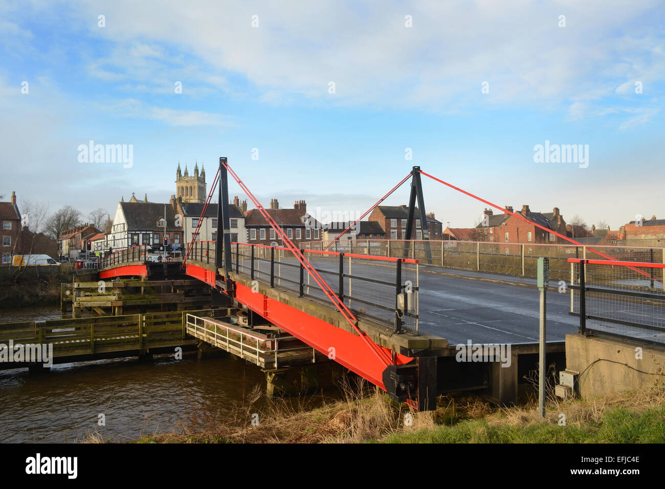 selby road swing bridge closing over the river ouse with selby abbey in the distance yorkshire united kingdom Stock Photo