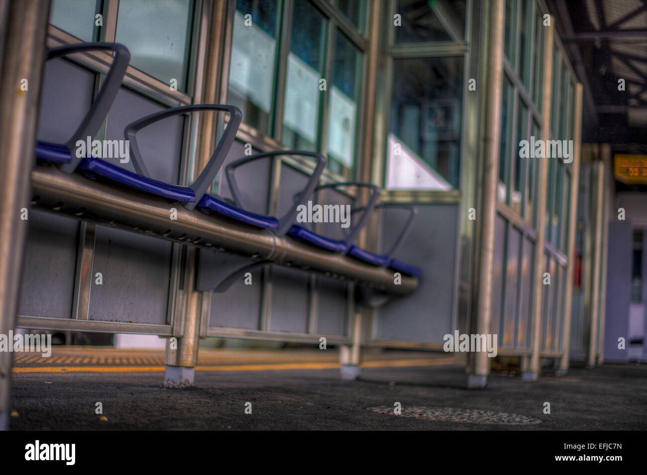 set of blue sheltered seat in a train station Stock Photo - Alamy
