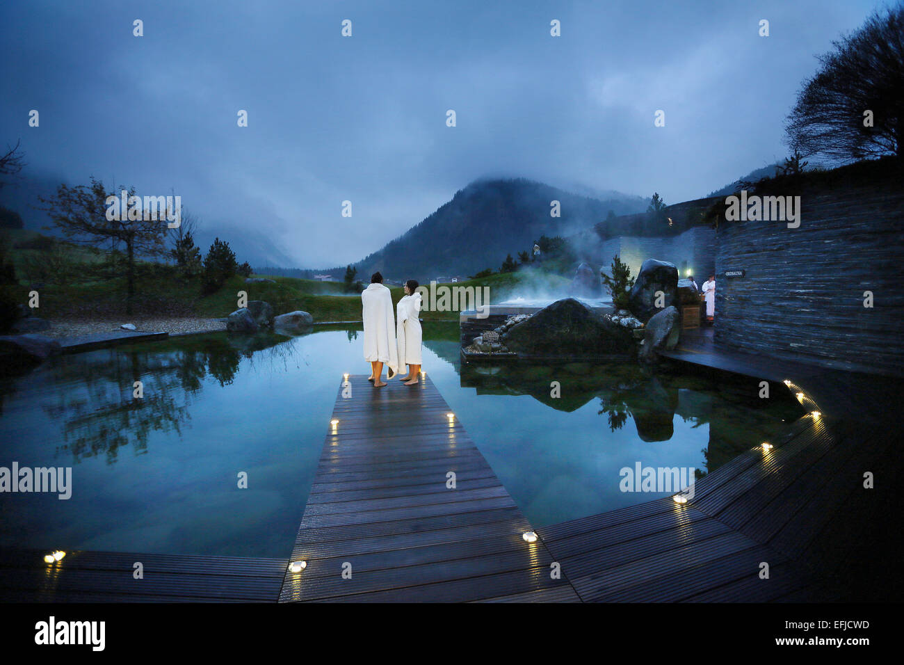 Hotel guests on a jetty at a natural source pond, Tannheim, Tannheim Valley, Tyrol, Austria Stock Photo