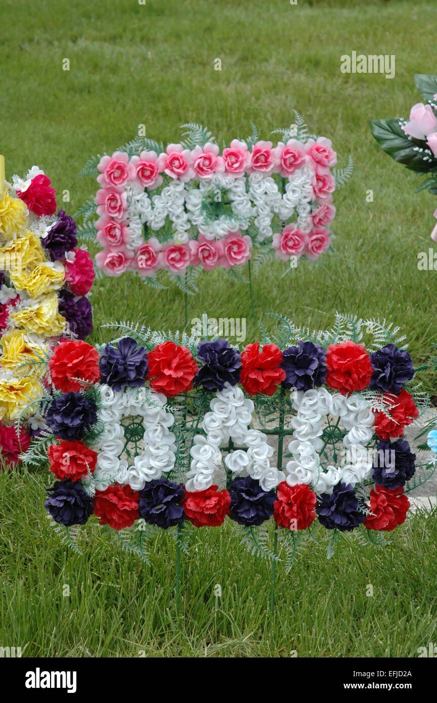 Plastic memorial flowers at cemetery Stock Photo Alamy