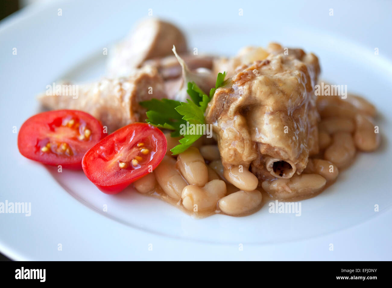 French cassoulet and tomato on a plate Stock Photo