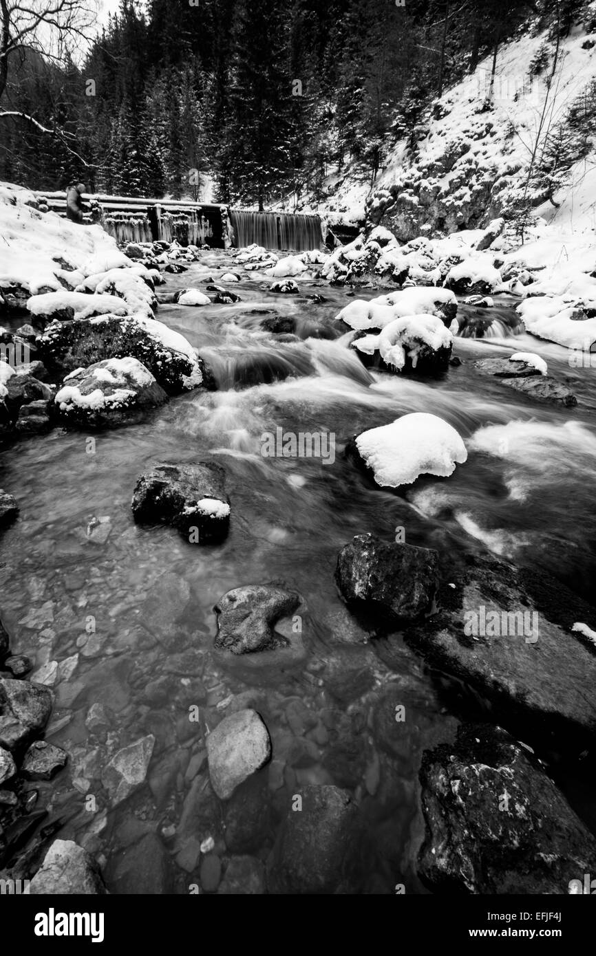 river flowing down the mountain in snowy lands Stock Photo - Alamy