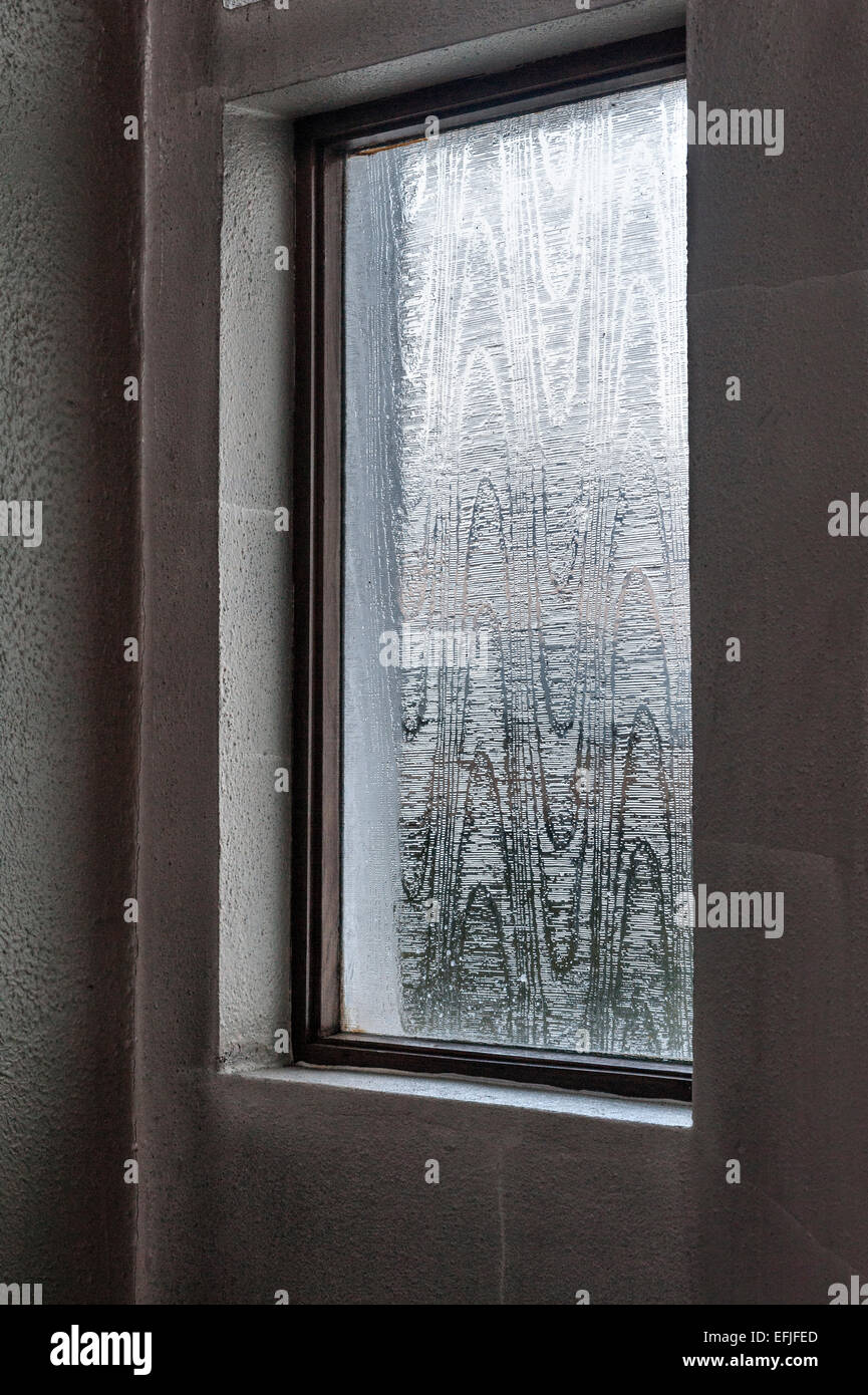 A frosted glass window (acid etched) in a concrete wall in a 1970's  building, UK Stock Photo - Alamy