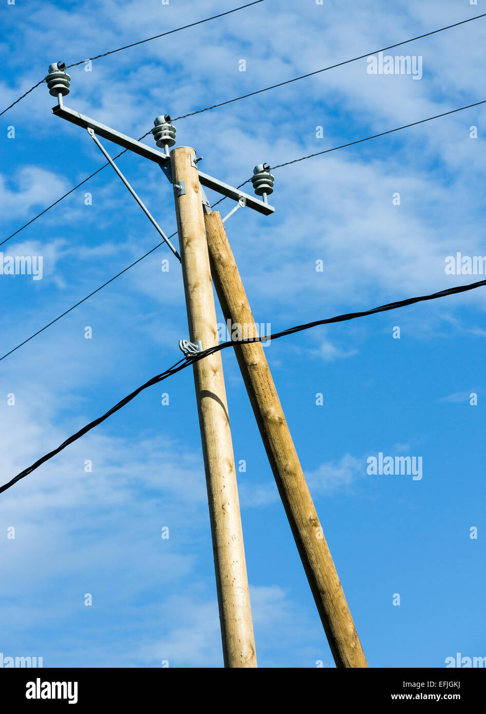 New wooden utility pole with power line wires , cross arm and insulators  against blue sky , Finland Stock Photo - Alamy