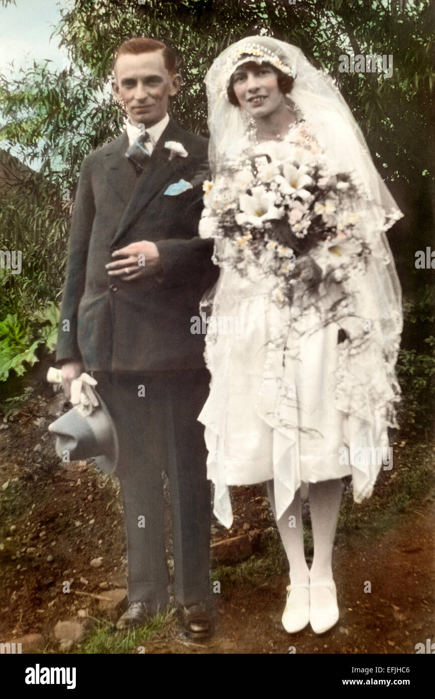 hand coloured monochrome print of a bride and her father during the 1920s england uk Stock Photo