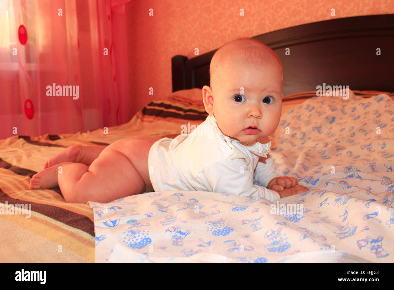 little lovely baby lying on the bed Stock Photo