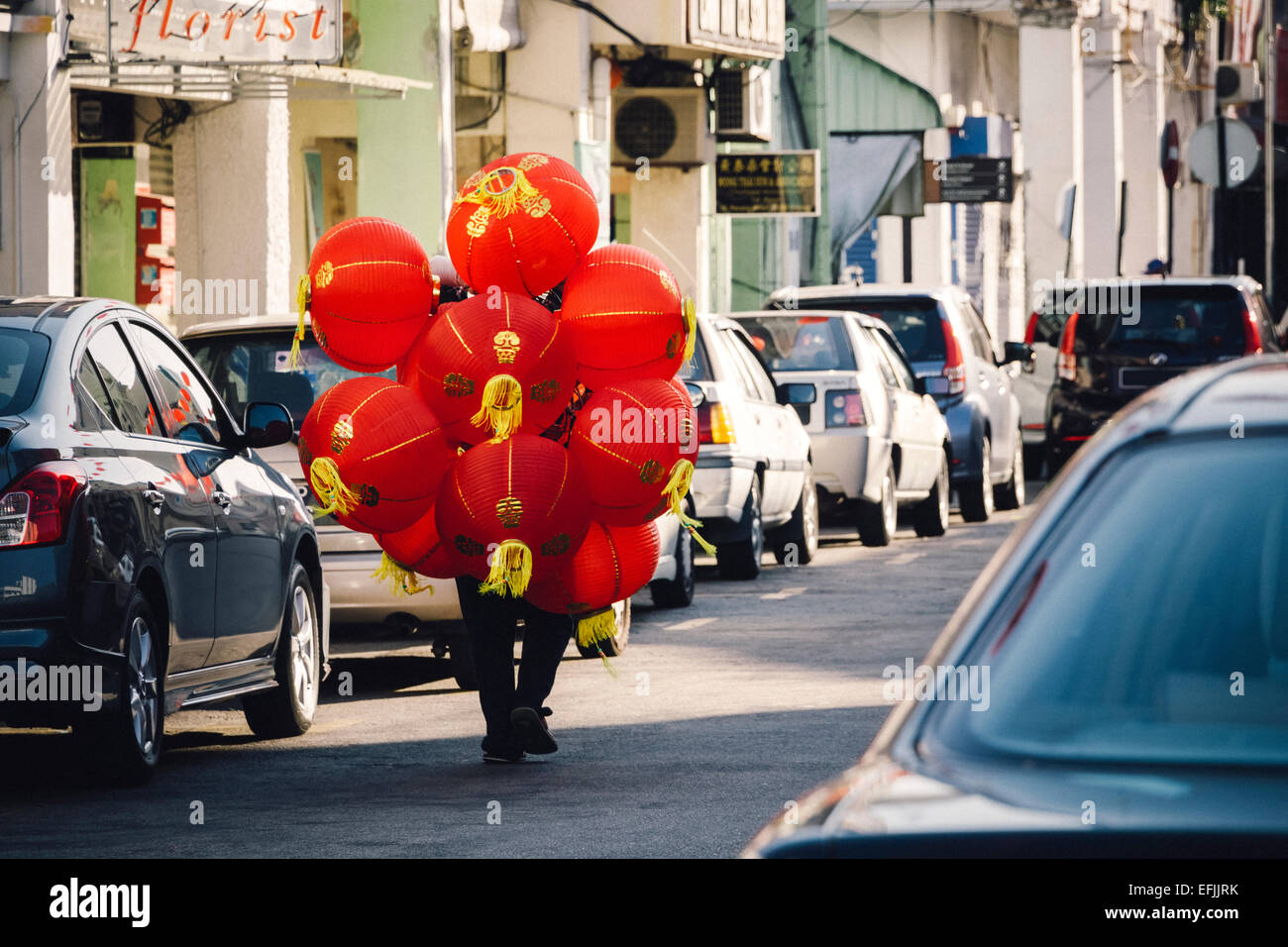 Man carrying chinese lanterns to be installed on the streets for chinese new year festival Stock Photo
