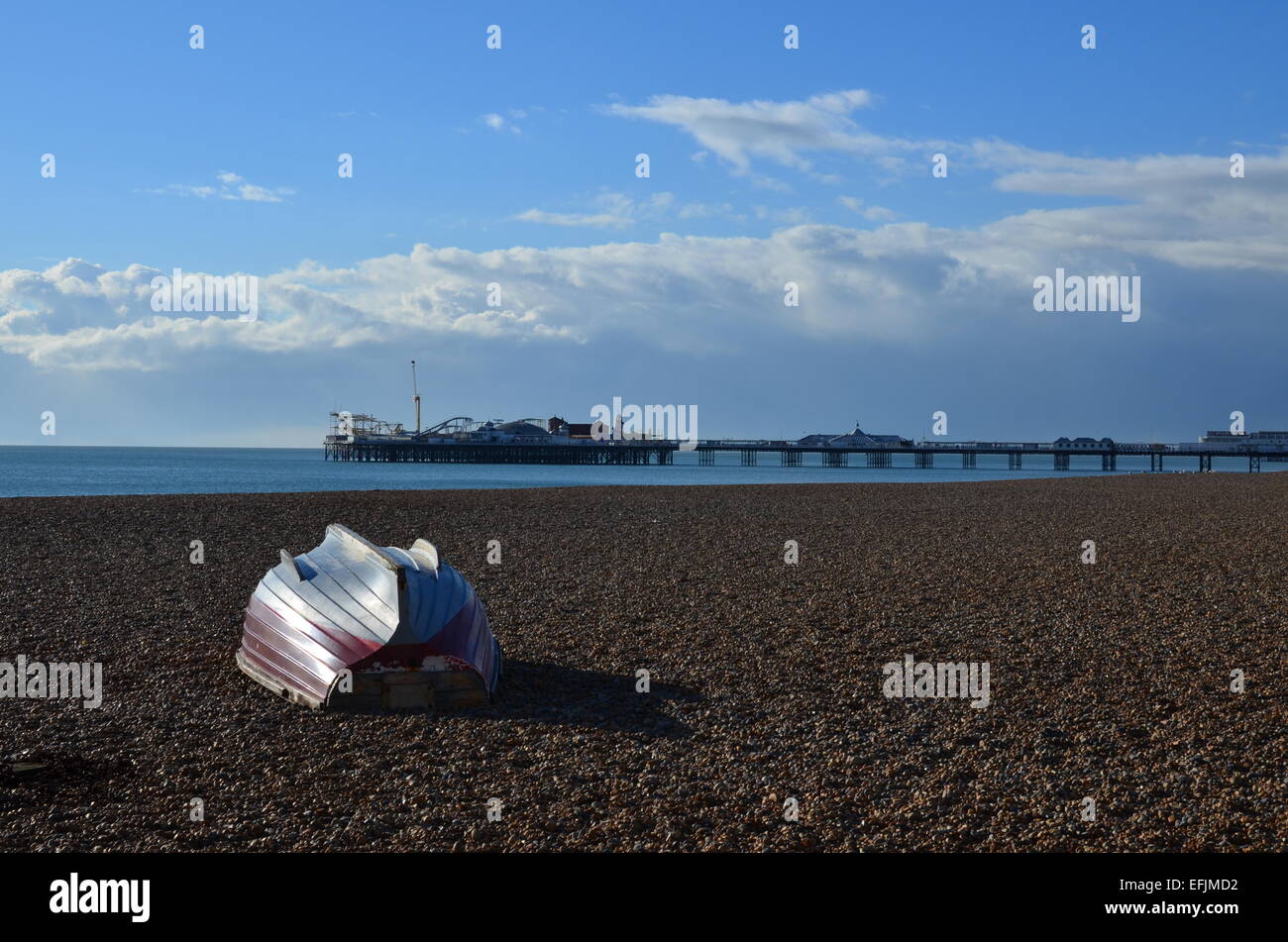 Small fishing boat on the famous pebble beach at Brighton in East ...