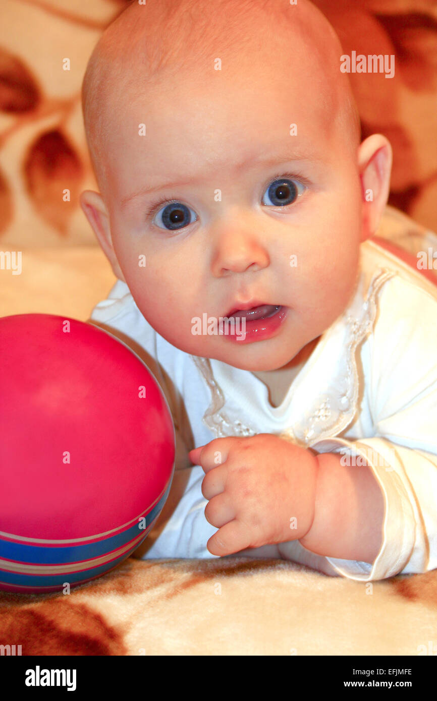 beautiful little baby playing with red ball Stock Photo Alamy