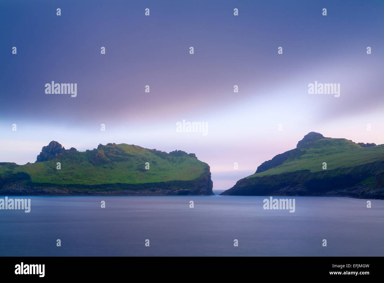 Dun and Ruaival are separated by a narrow sea strait, limiting the access to Dun. Seen from across the Village Bay, St Kilda. Stock Photo