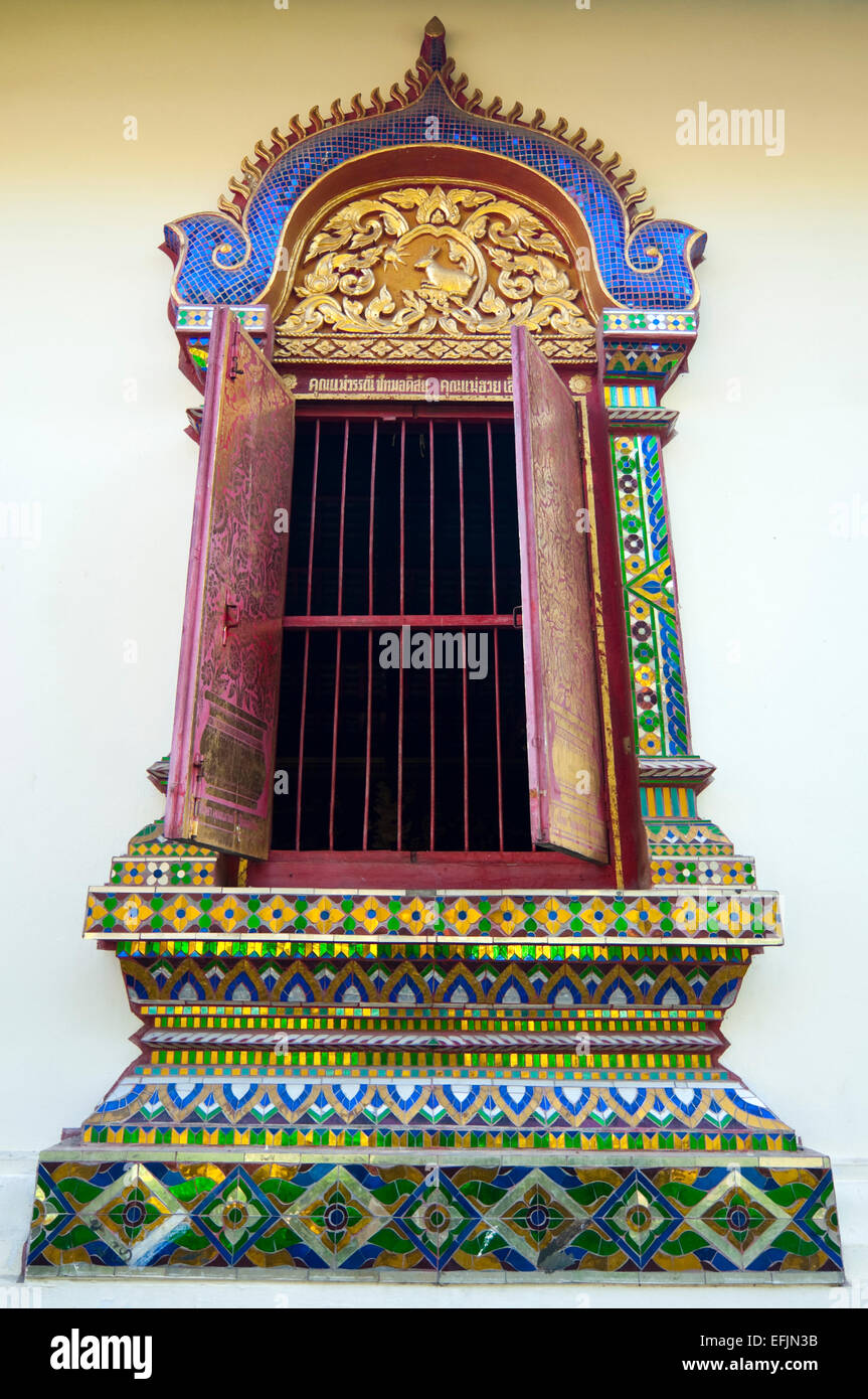 Vertical view of an ornate window at the Wat Chiang Mun, the oldest temple in Chiang Mai in Thailand. Stock Photo