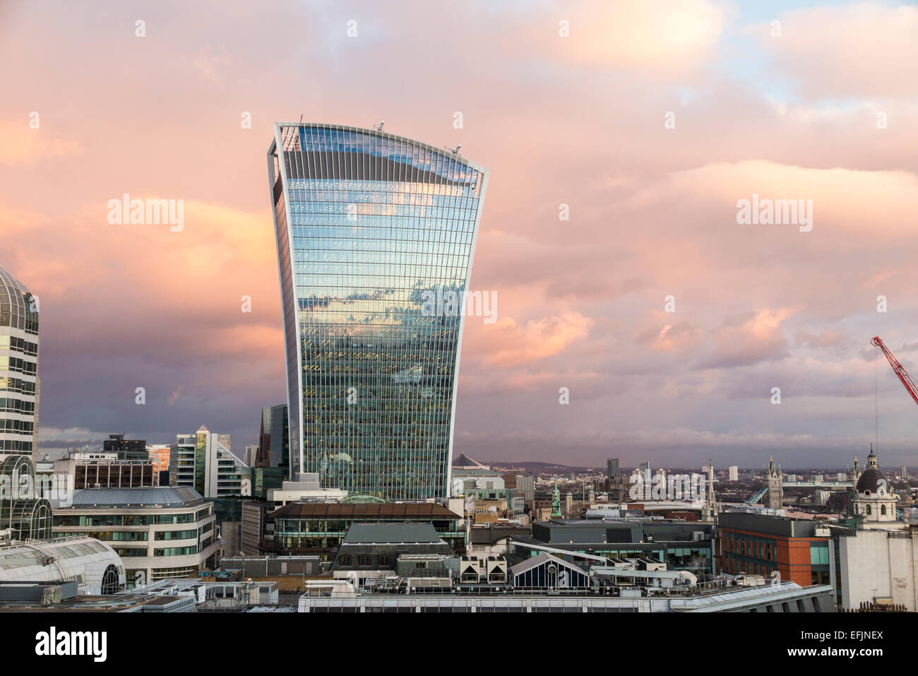 Walkie Talkie building, 20 Fenchurch Street, in the evening in City of London, reflecting the blue sky at sunset with pink sky Stock Photo