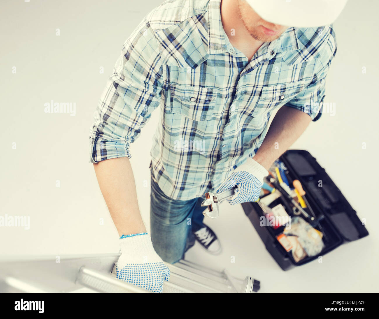 man with ladder, toolkit and spanner Stock Photo