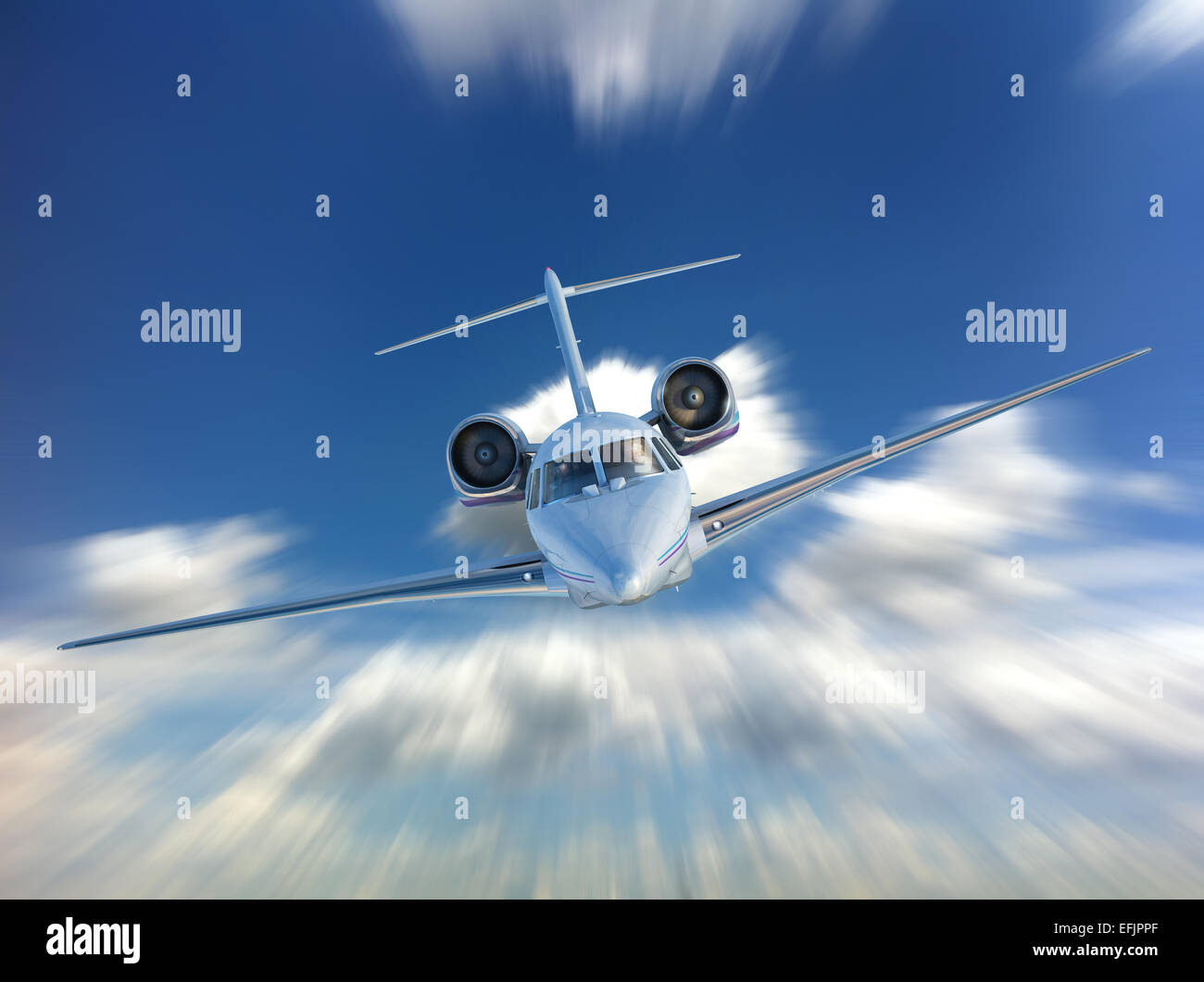 Private Jet airplane flying. Front view, on Sky and clouds background. With speed motion blur effect. Stock Photo