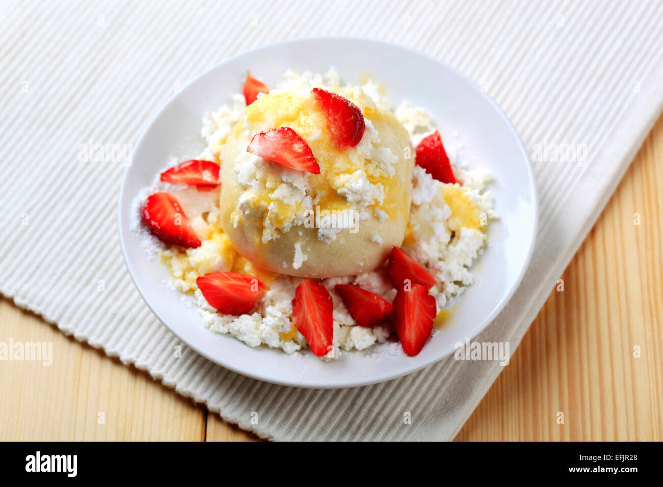 Strawberry dumpling served with cottage cheese, sugar, butter and fresh strawberries Stock Photo