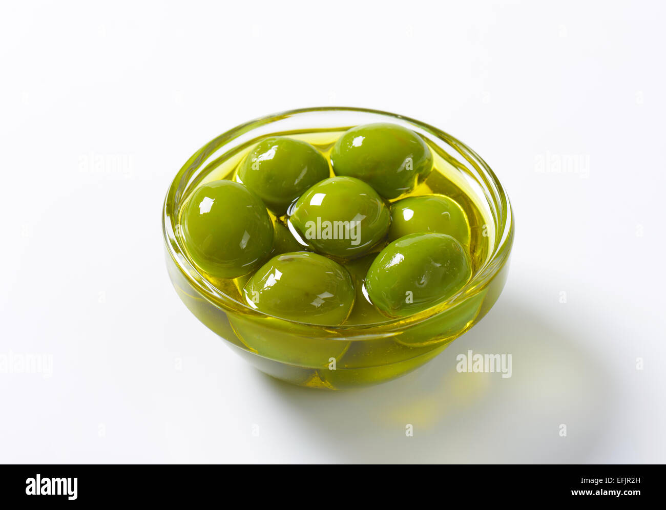 Bowl of green olives in oil Stock Photo Alamy