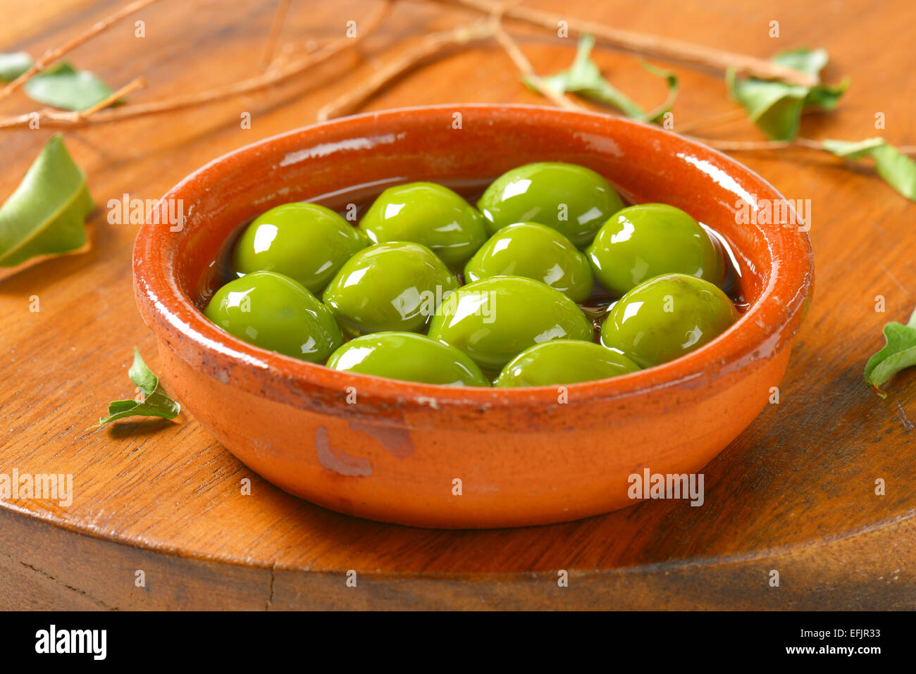 Bowl of green olives in oil Stock Photo Alamy