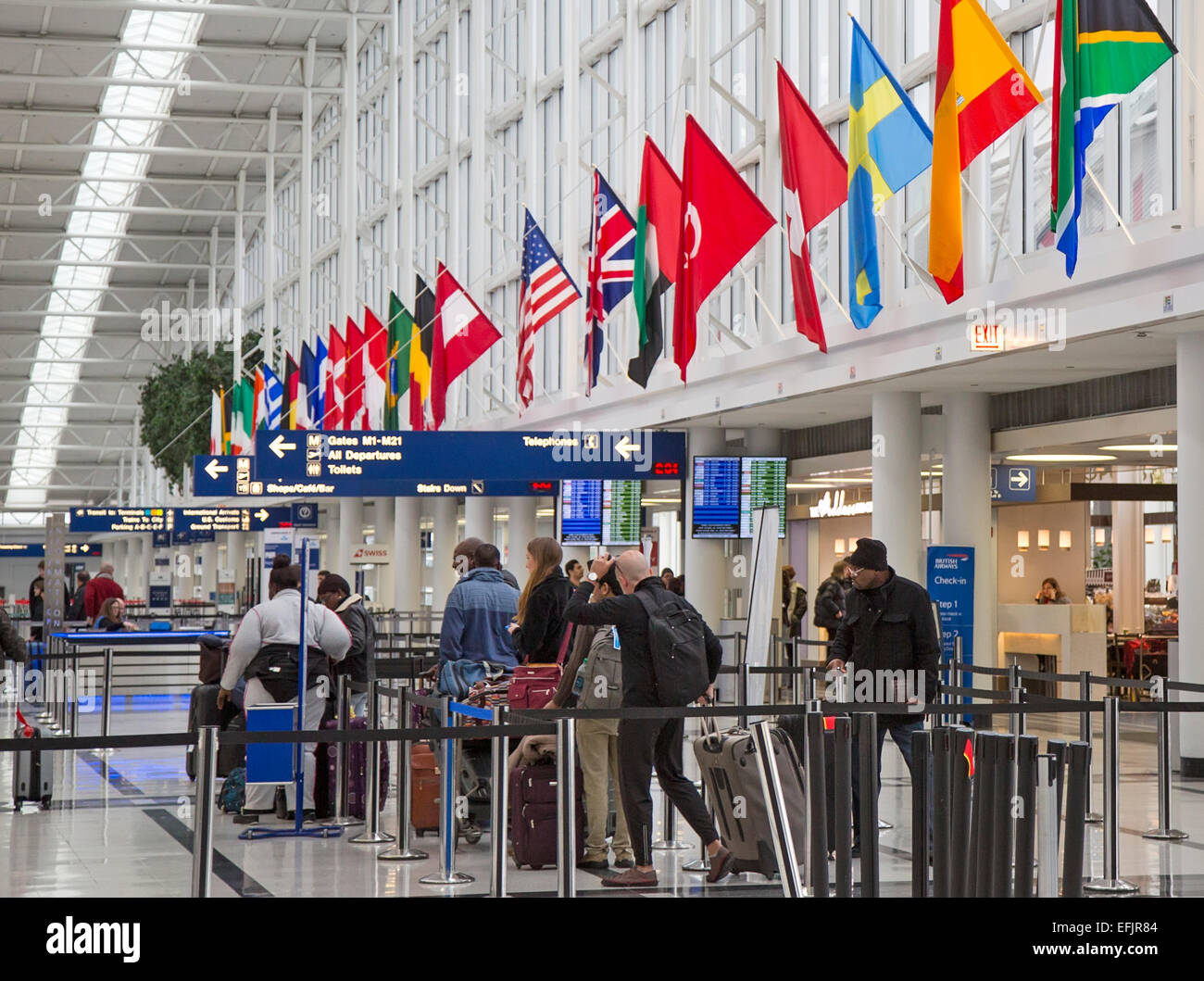 Chicago, Illinois - Passengers waiting in line to check in for flights at O'Hare International Airport's international terminal. Stock Photo