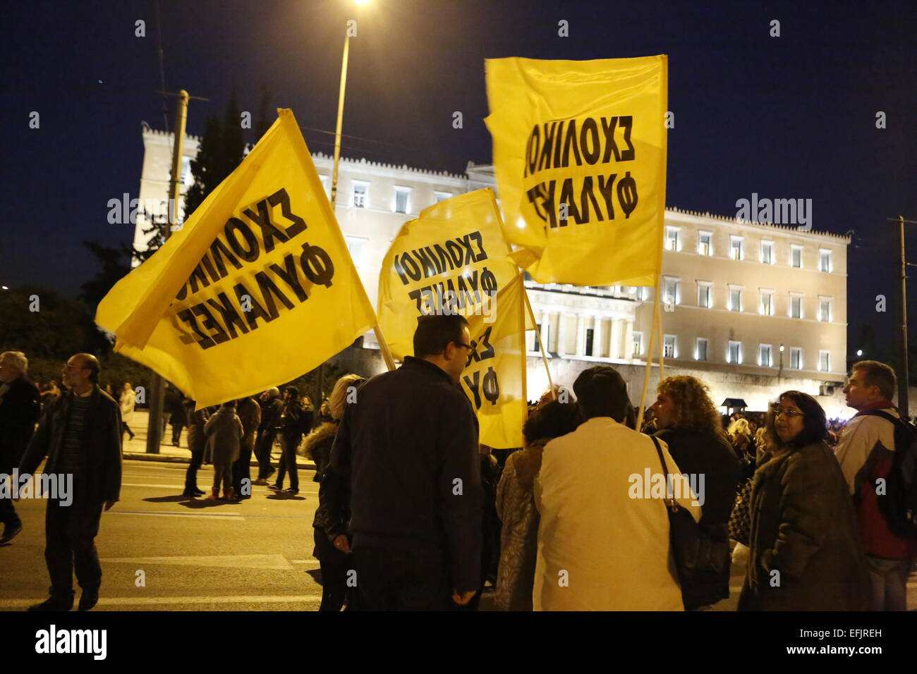 Athens, Greece. 5th Feb, 2015. Protesters with flags stand outside the Greek Parliament. Thousands of Greeks assembled at Syntagma Square, to protest against the fiscal extortion by the Troika, who wants Greece to follow their instruction in return for providing needed money to the Greek banks. Credit:  Michael Debets/Pacific Press/Alamy Live News Stock Photo