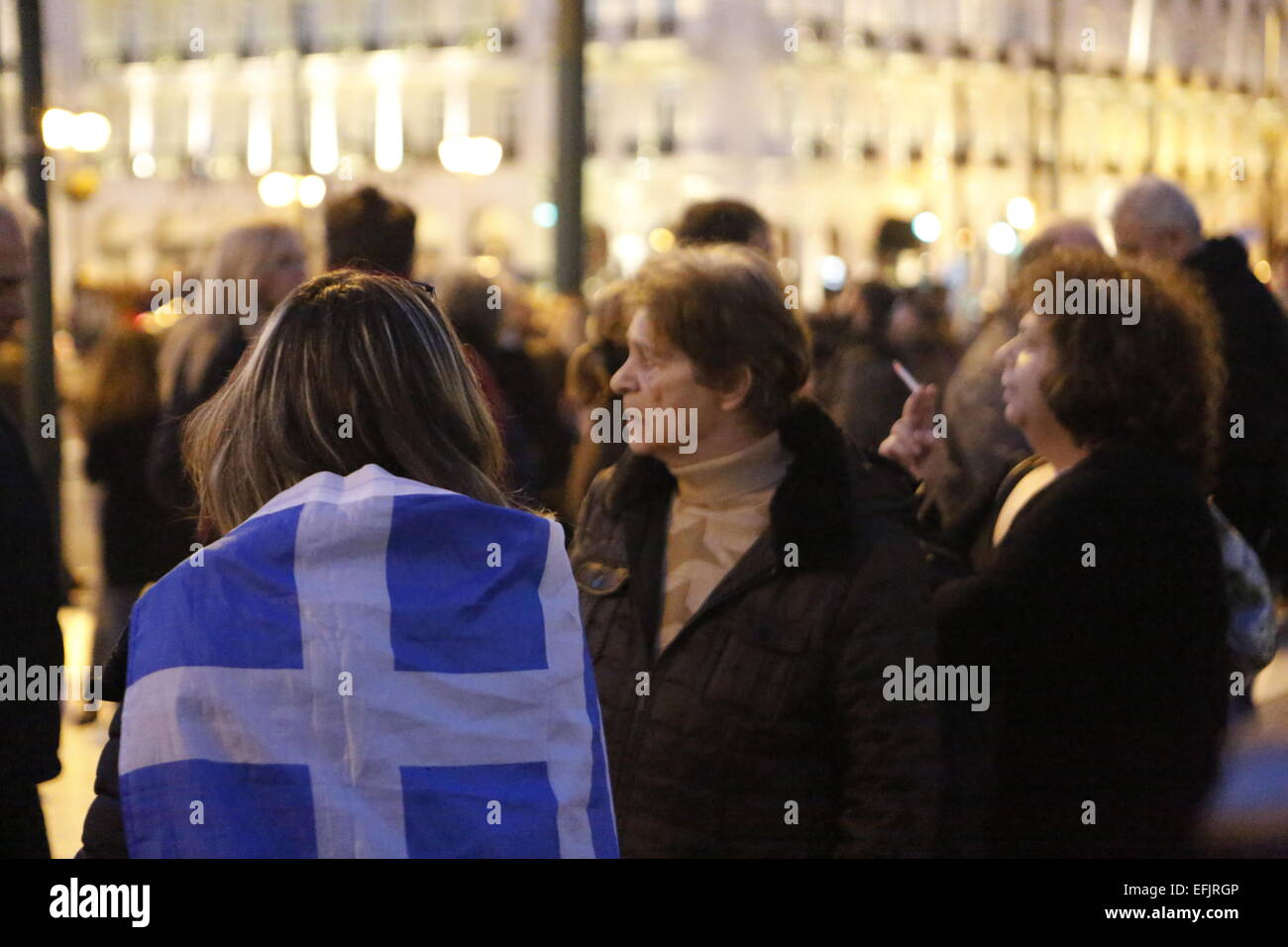 Athens, Greece. 5th Feb, 2015. A woman is wrapped in a Greek flag. Thousands of Greeks assembled at Syntagma Square, to protest against the fiscal extortion by the Troika, who wants Greece to follow their instruction in return for providing needed money to the Greek banks. Credit:  Michael Debets/Pacific Press/Alamy Live News Stock Photo
