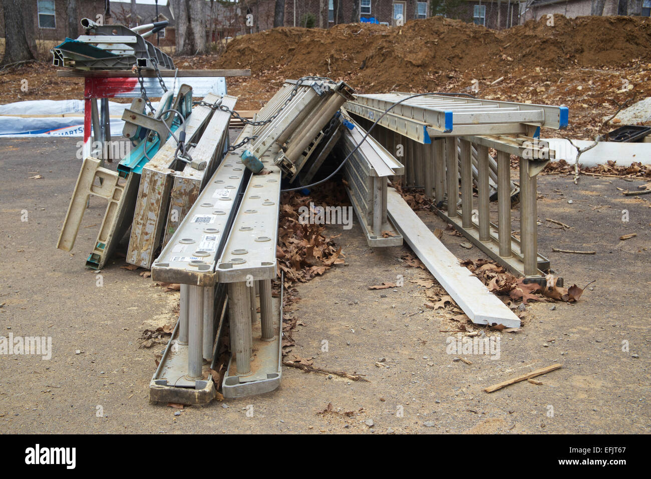 Ladders piled up together at a construction site Stock Photo Alamy