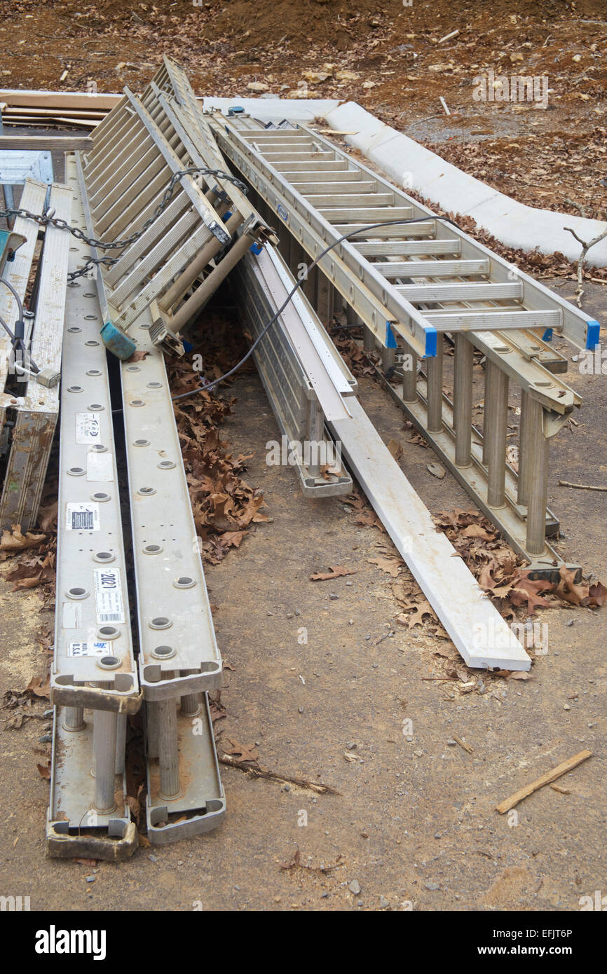 Stack of ladders on ground at a construction site Stock Photo Alamy