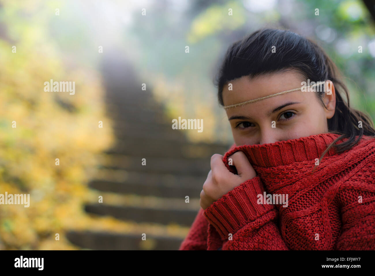 beautiful woman freezing in autumn park Stock Photo