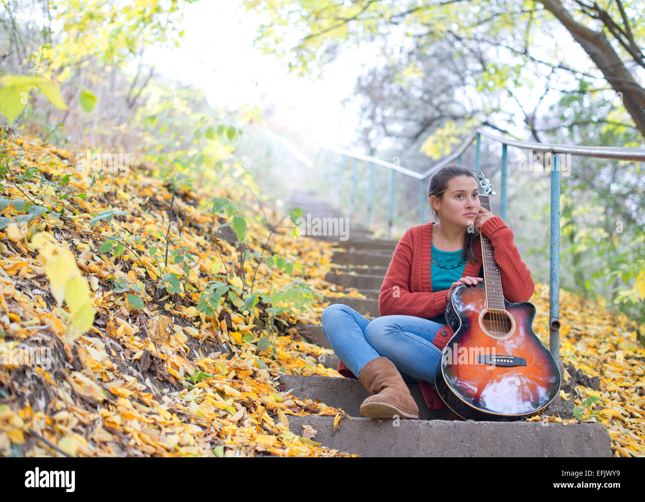 Meditative girl with her guitar Stock Photo