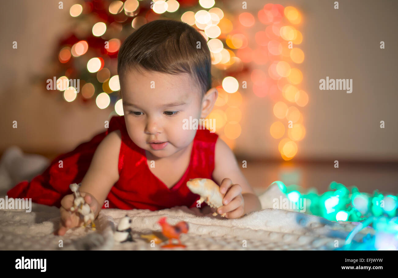little girl playing wtih her toys at Christmas Stock Photo - Alamy