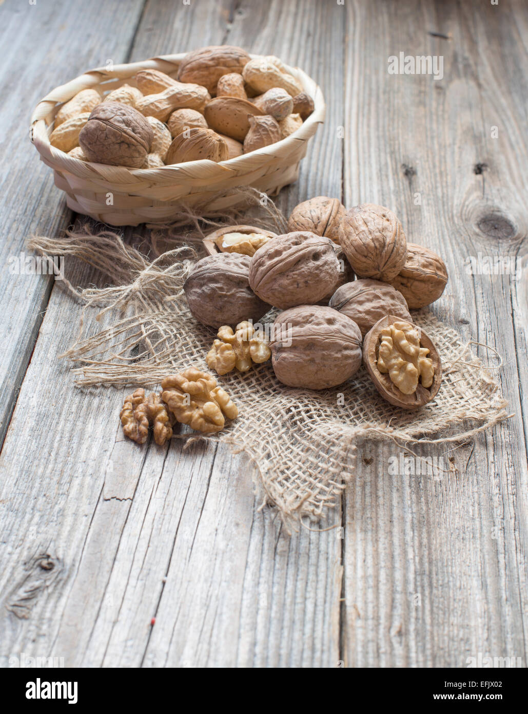 Heap of walnuts in a bowl  and some around Stock Photo