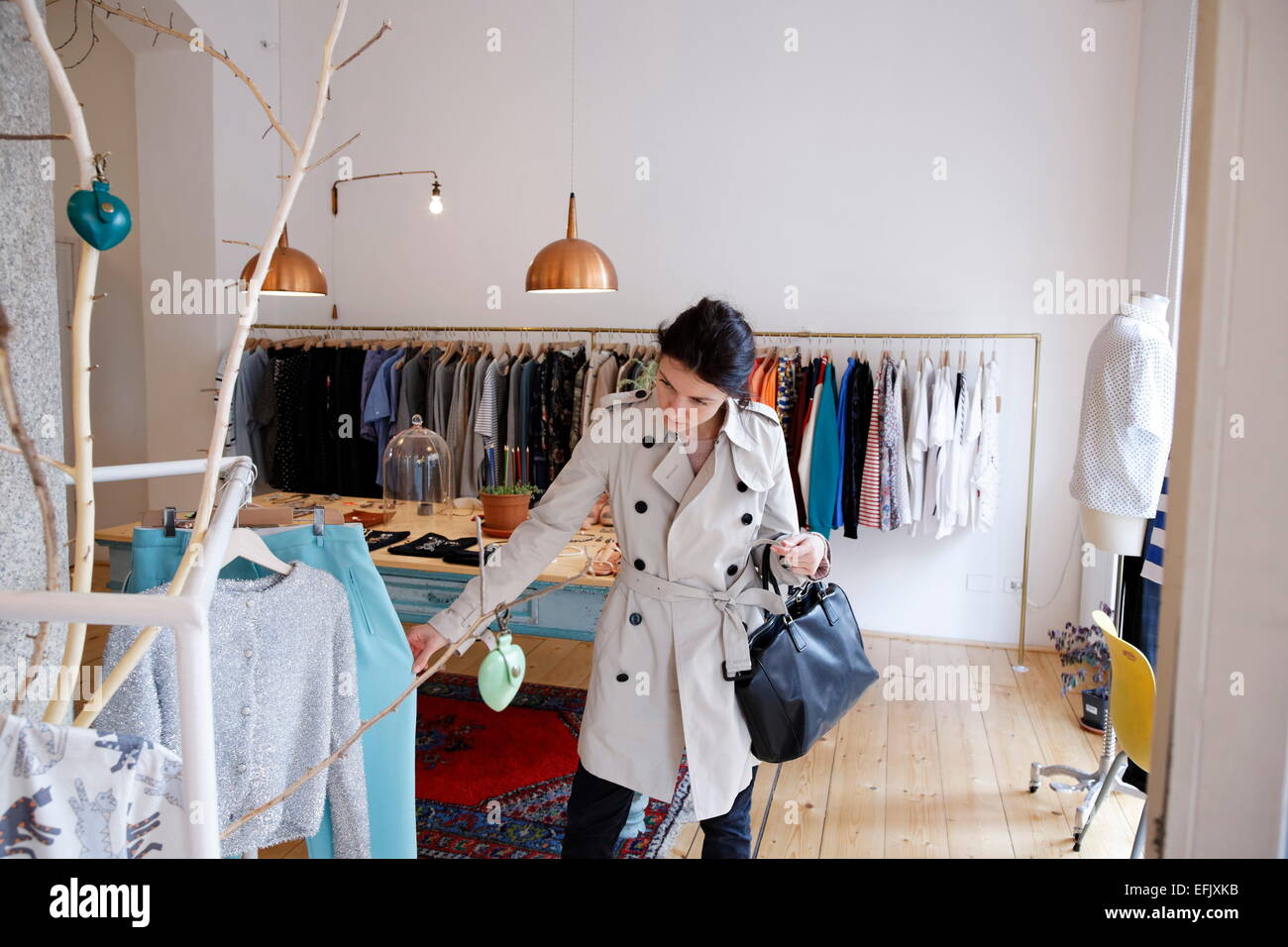 Woman shopping in a fashion boutique, Navigli, Milan, Lombardy, Italy Stock Photo