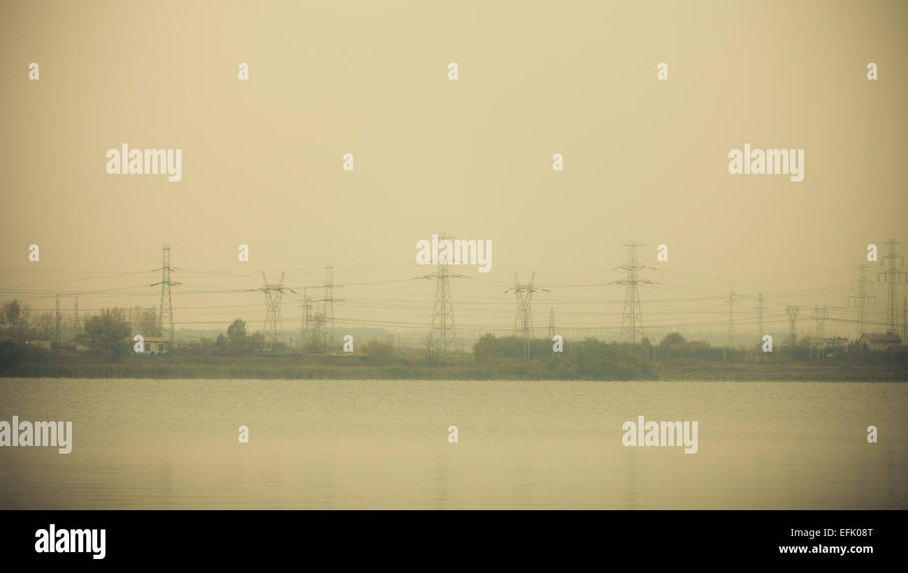 High voltage electric power transmission towers pylons in sunset sky ...