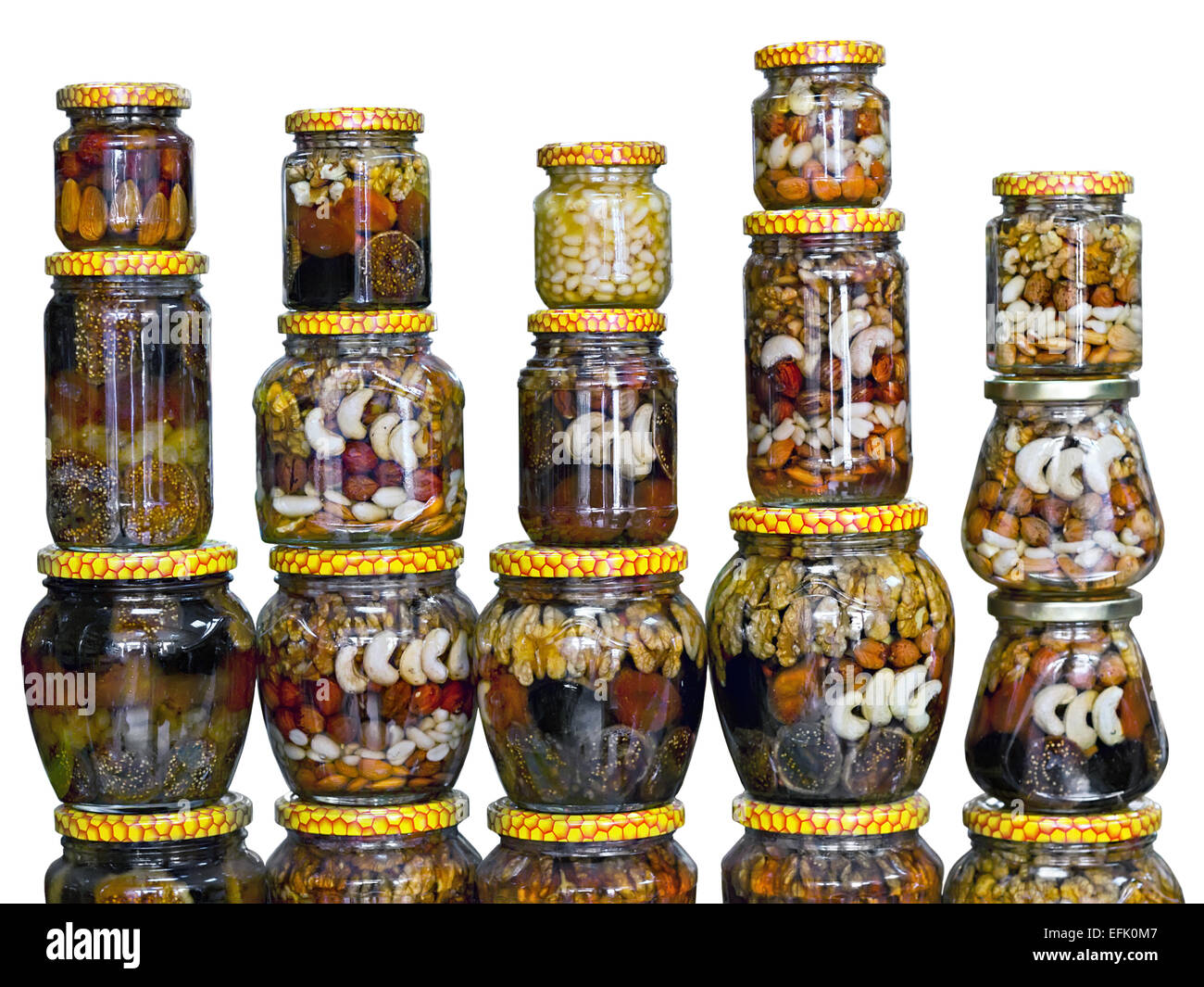 glass jars with nuts and honey isolated on white background Stock Photo