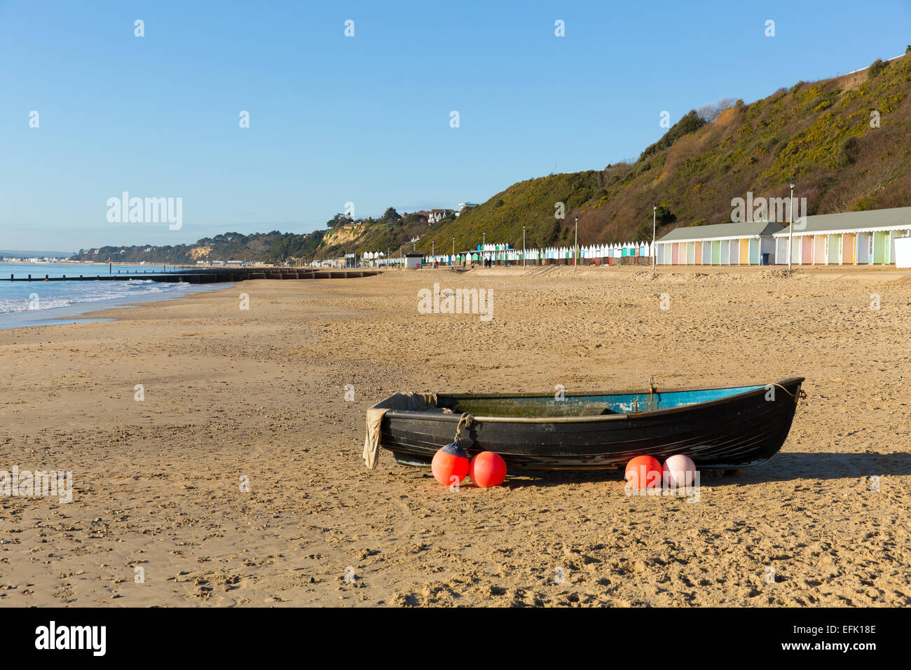 Wooden rowing boat with buoys and buoyancy aids Bournemouth beach Dorset England UK near to