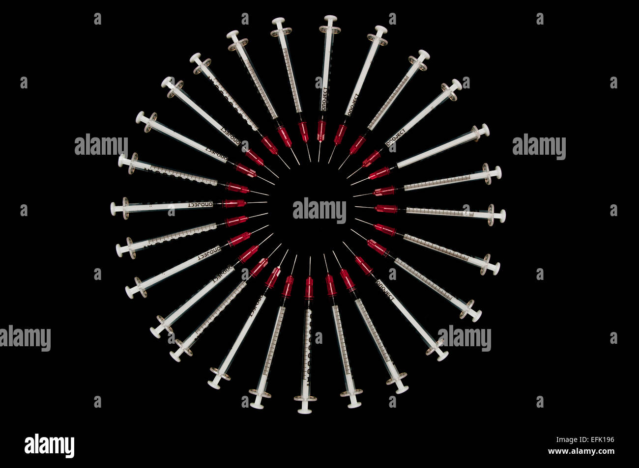 syringes arranged in a circle Stock Photo