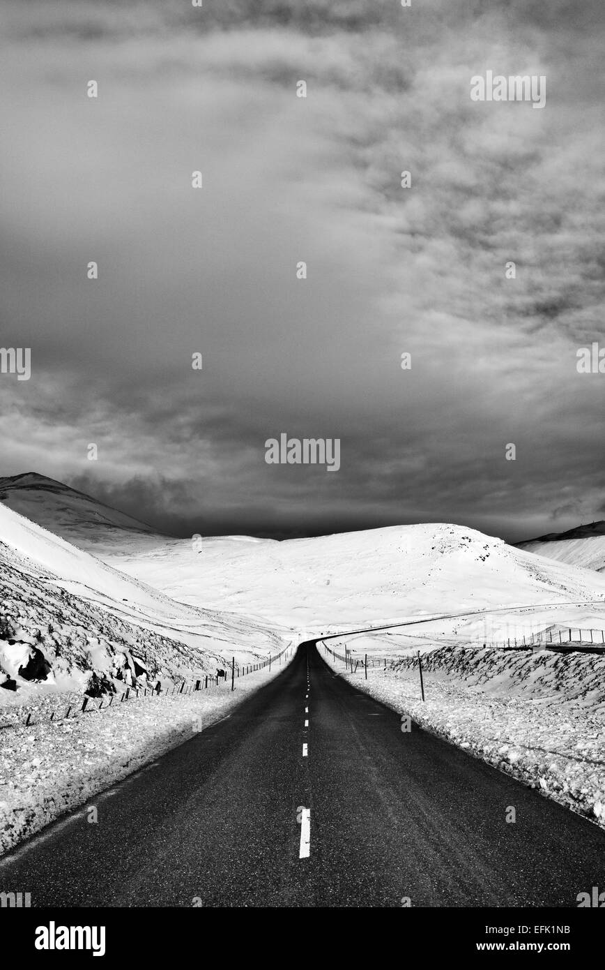 Braemar Pass through Cairngorms National Park in winter snow. Scottish Highlands. Scotland. Black and white Stock Photo