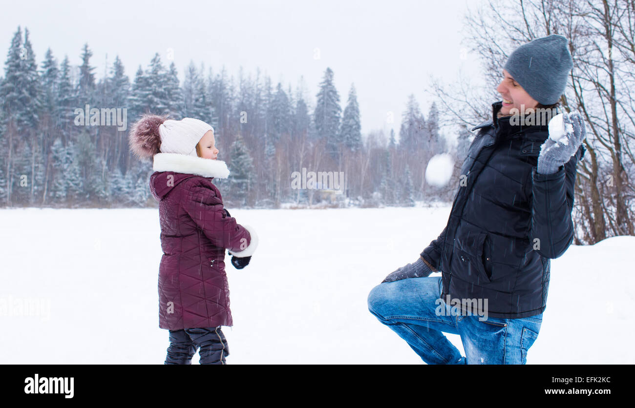 Happy family playing snowballs in winter snowy day Stock Photo - Alamy
