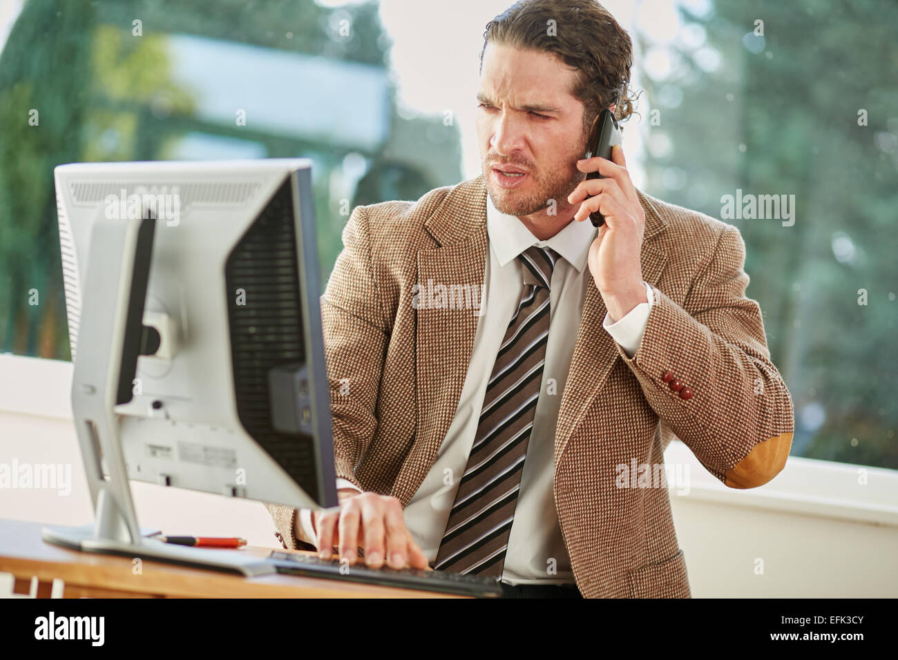 Man stressed out at work Stock Photo