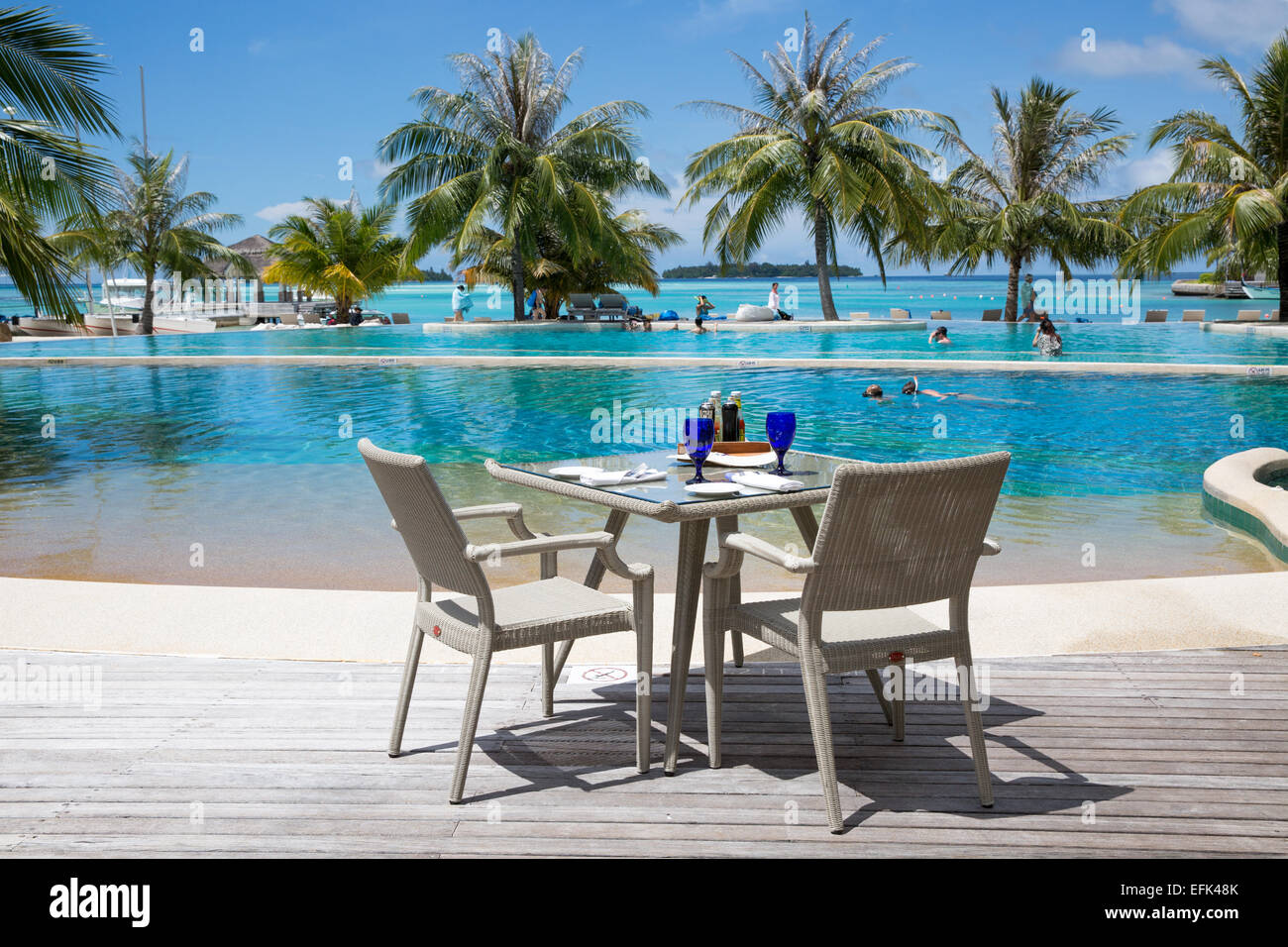Pool and poolside dining by the sea at Kandooma island resort Maldives Stock Photo
