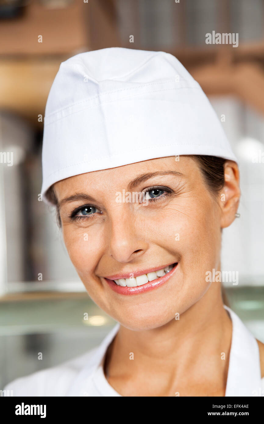 Female Butcher Smiling In Butchery Stock Photo