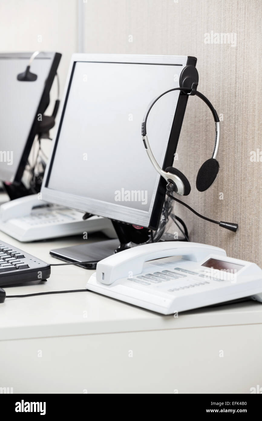 Headphone Hanging On Computer Monitor Stock Photo