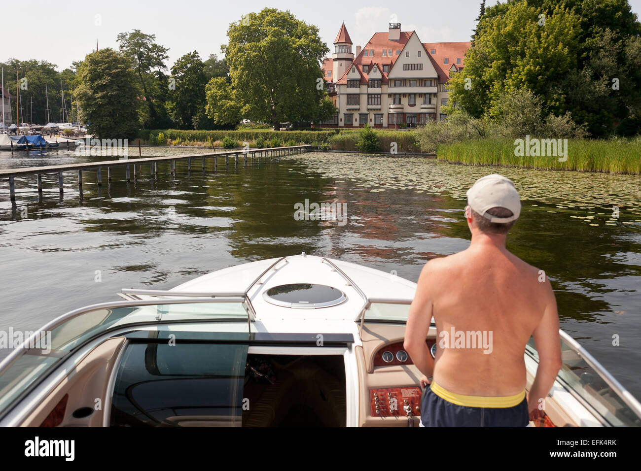 yacht owner driving his boat head towards a luxurious country villa, photo: July 26, 2012. Stock Photo