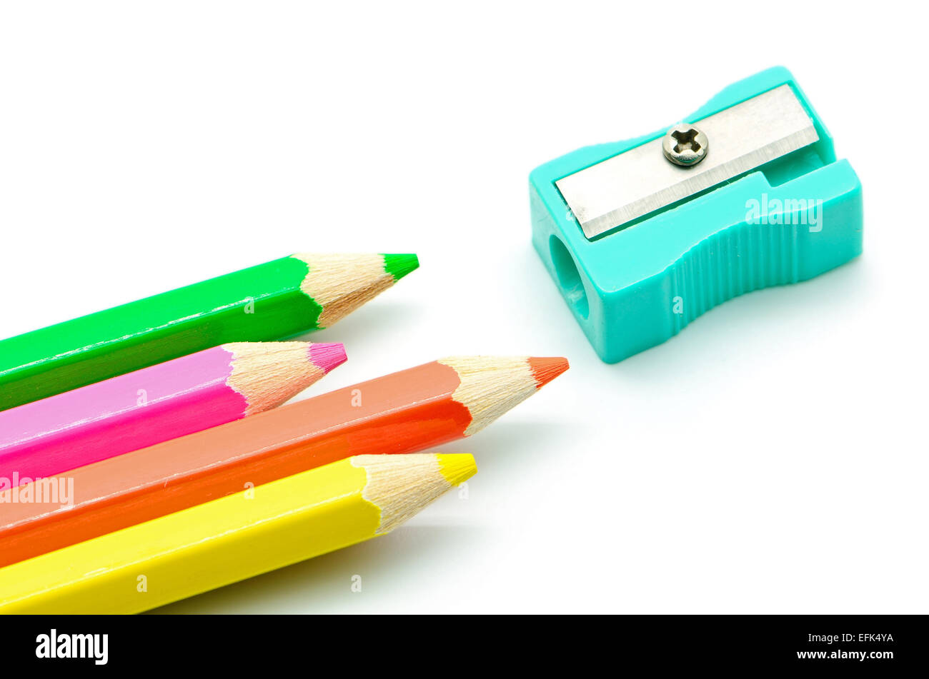 Colored pencils and sharpener isolated on white background close up Stock Photo