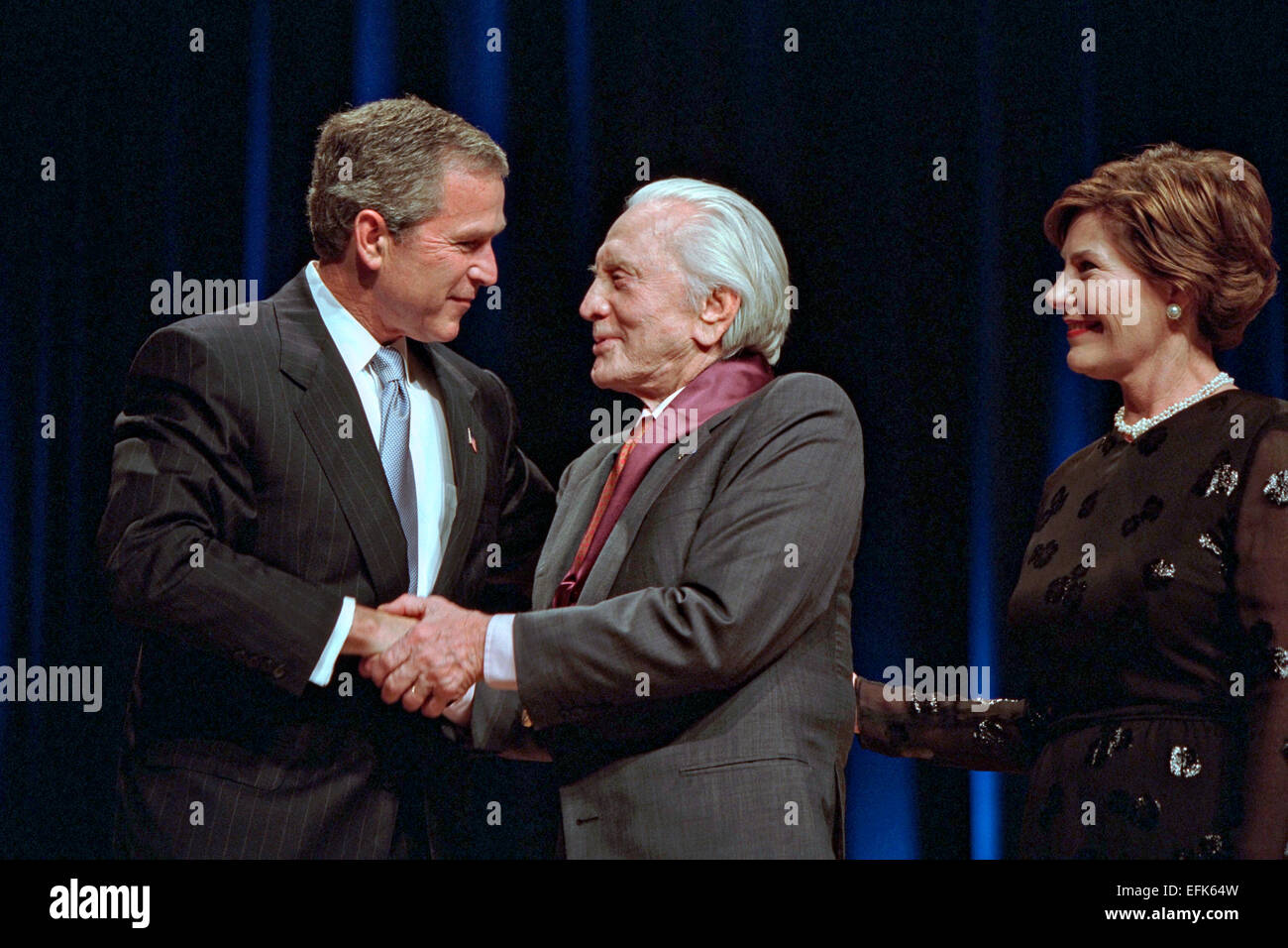 US President George W. Bush and First Lady Laura Bush present the 2001 National Medal of Arts and National Humanities Awards to actor Kirk Douglas at the DAR Constitution Hall April 22, 2002 in Washington, DC. Stock Photo