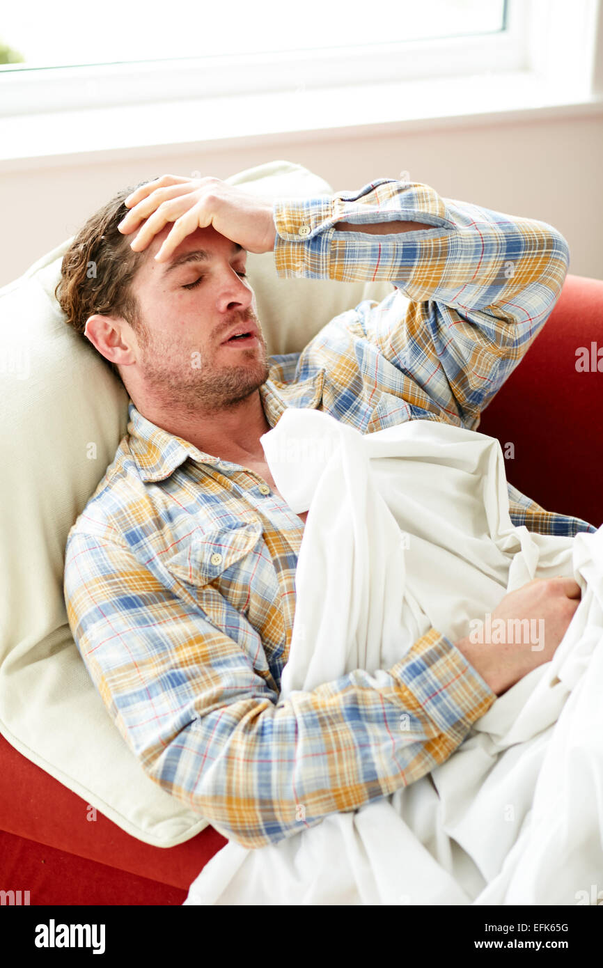 Man laid in bed unwell Stock Photo