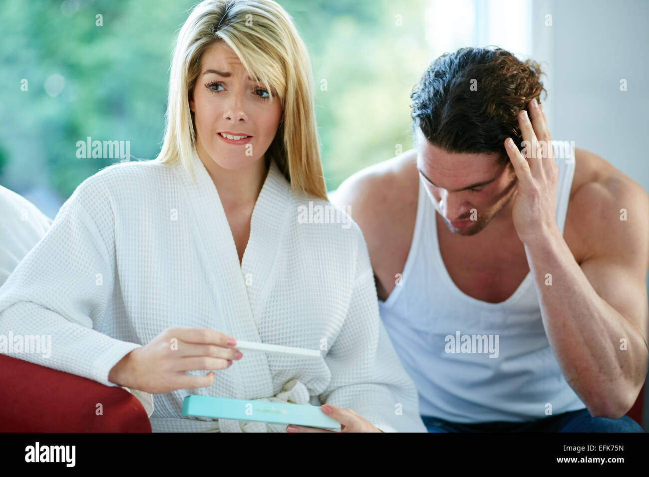 Unhappy couple finding out she is pregnant Stock Photo