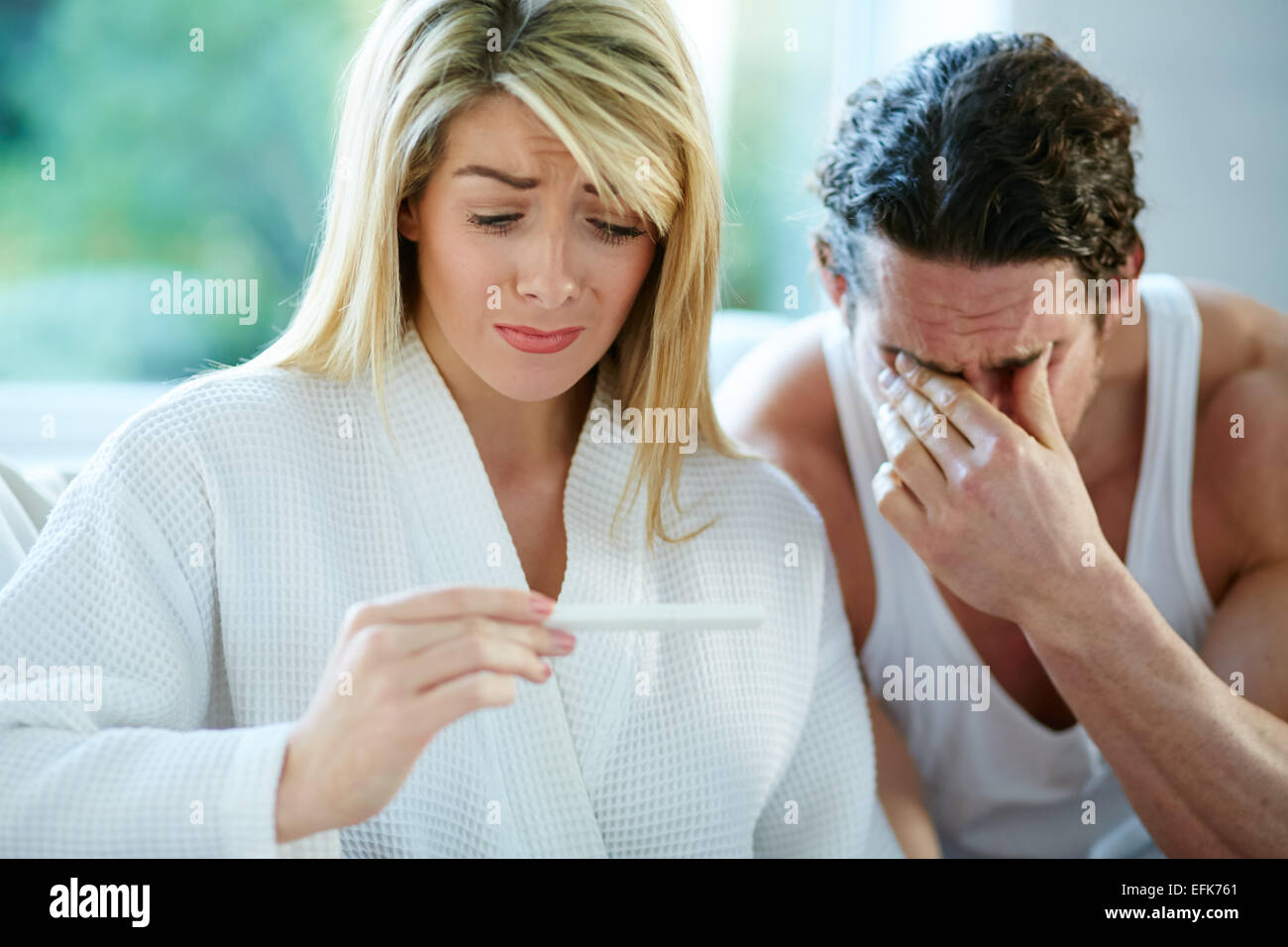 Unhappy couple finding out she is pregnant Stock Photo