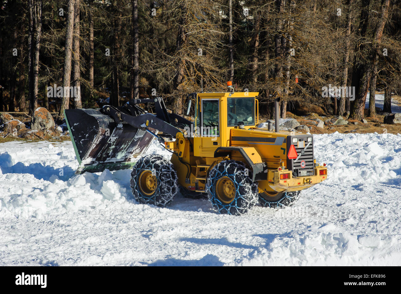 Snow removing with big bulldozer Stock Photo