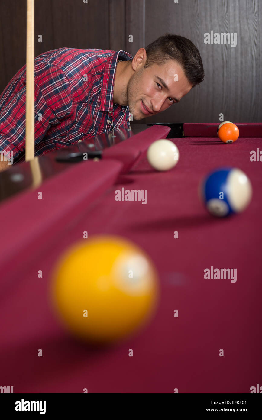 Young man playing billiard Stock Photo