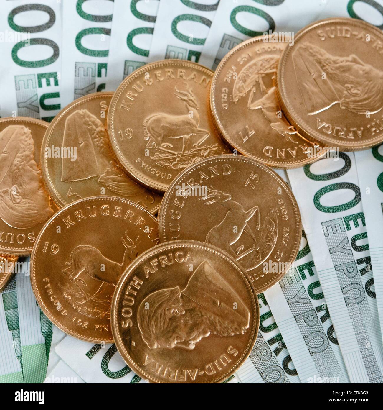 Krugerrand gold coins and euro bills Stock Photo